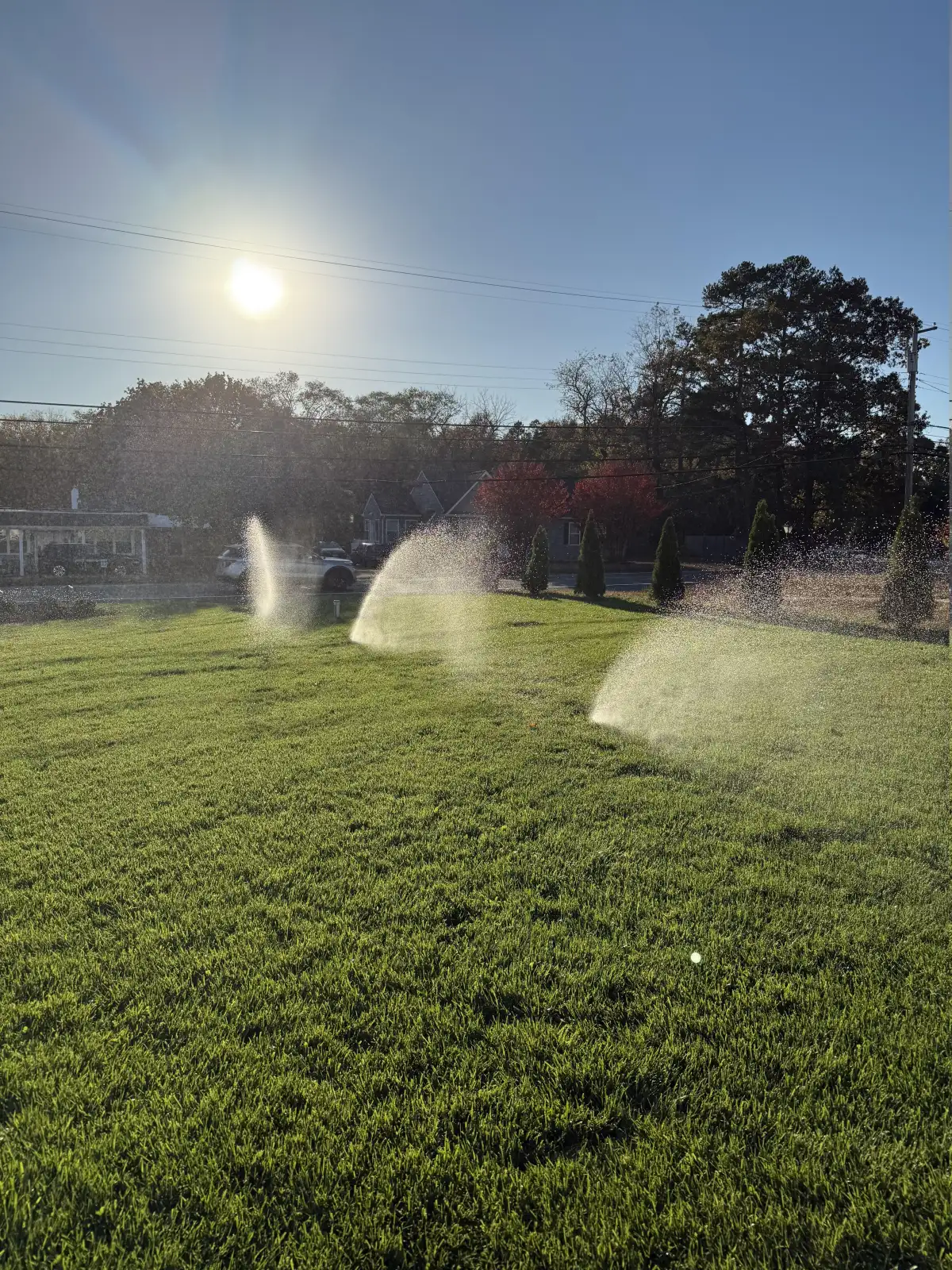 Sprinkler system running during golden hour in South Jersey