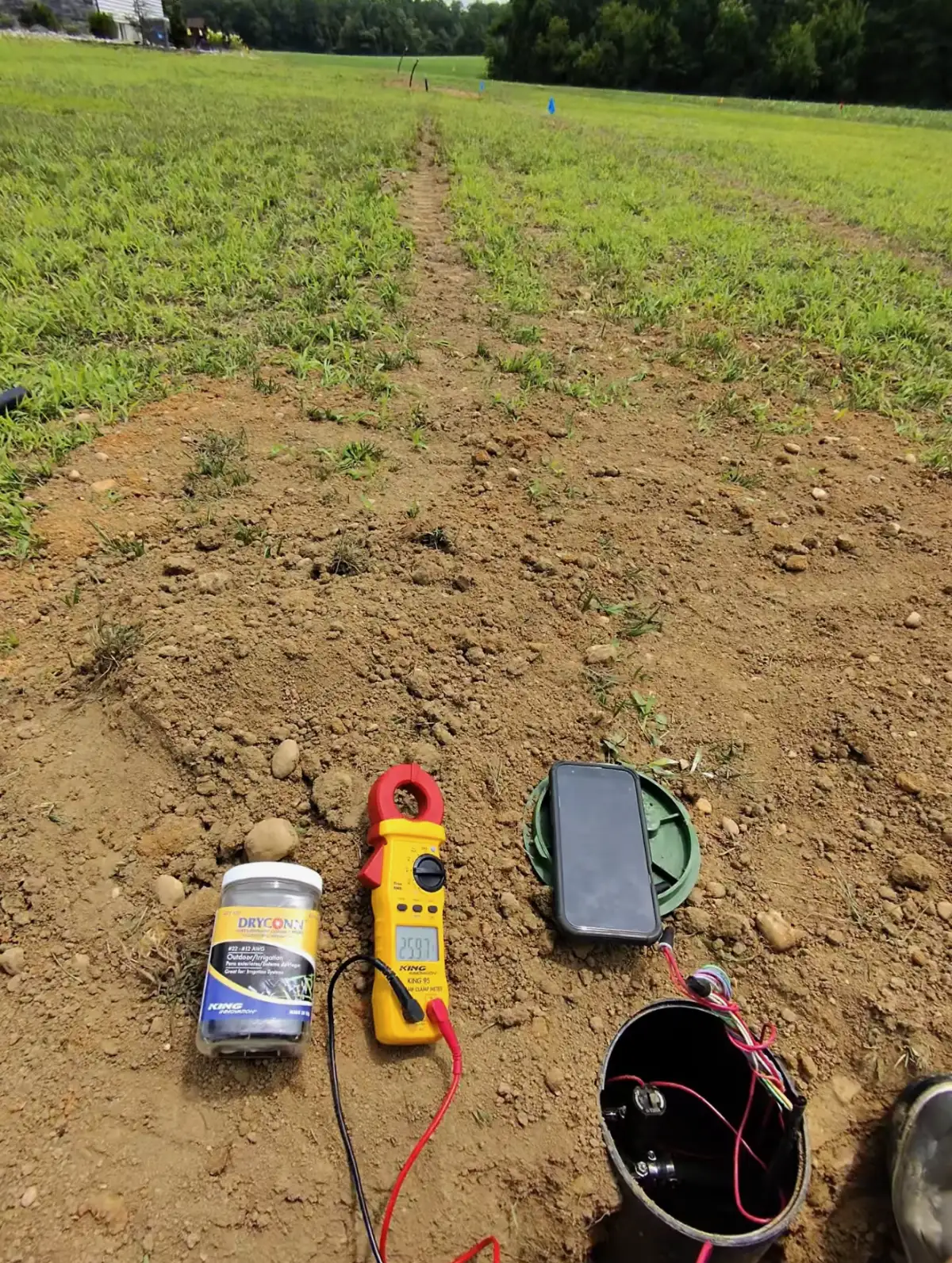 Irrigation technician diagnosing sprinkler valve box issue in South Jersey