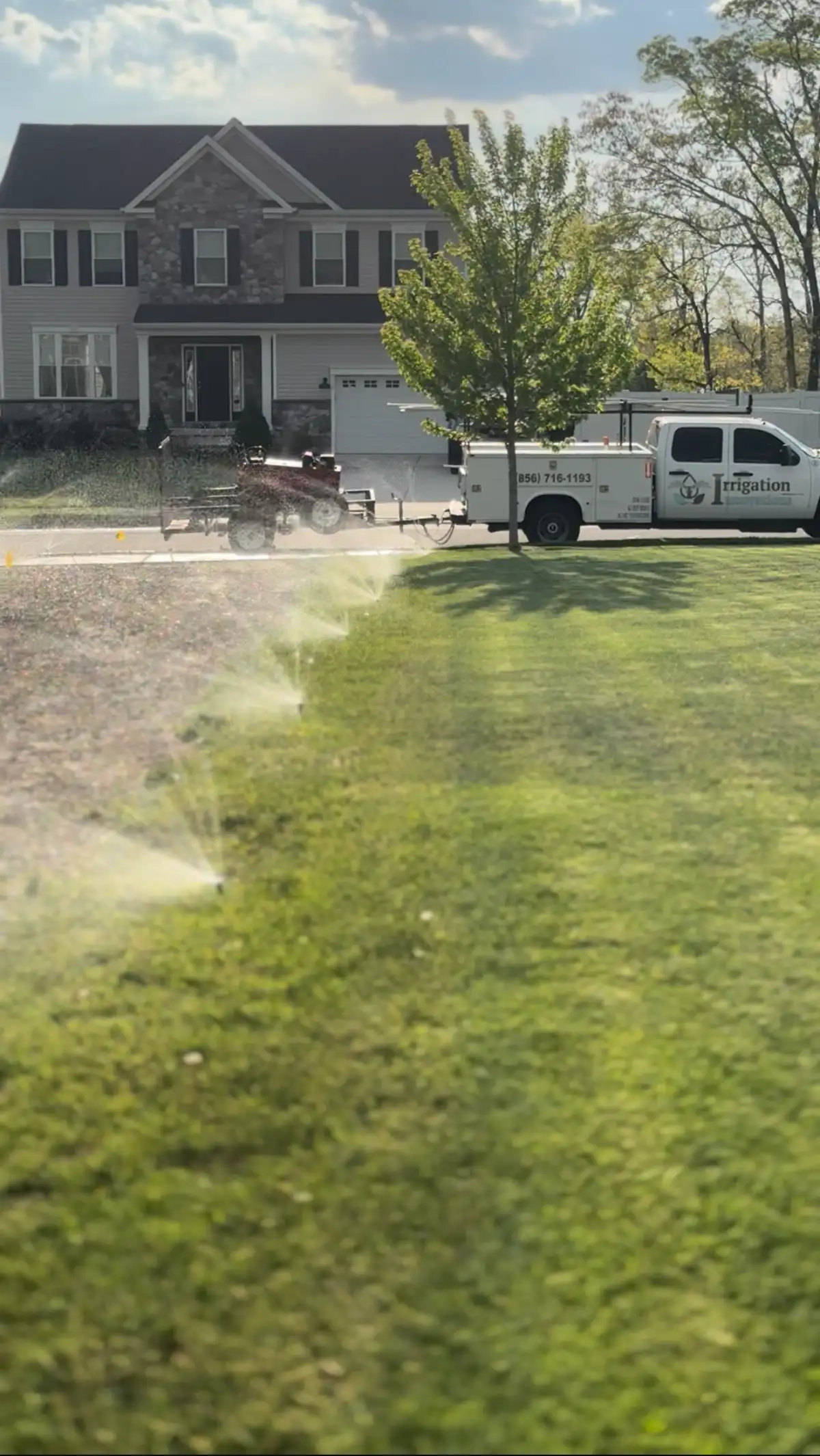 Sprinkler system running near an Irrigation Innovations truck in Gloucester County