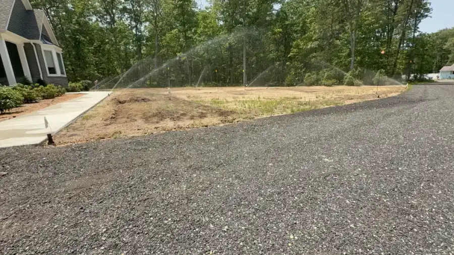Sprinkler heads watering turf at a newly built South Jersey property